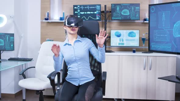 Young Female Using Virtual Reality Goggles in a Neurology Lab Science