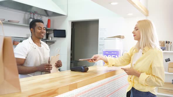 Affable Cafe Worker Serve Clients, Give Takeaway Orders