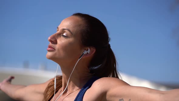 Relaxed Woman with Closed Eyes Exercising Outdoor