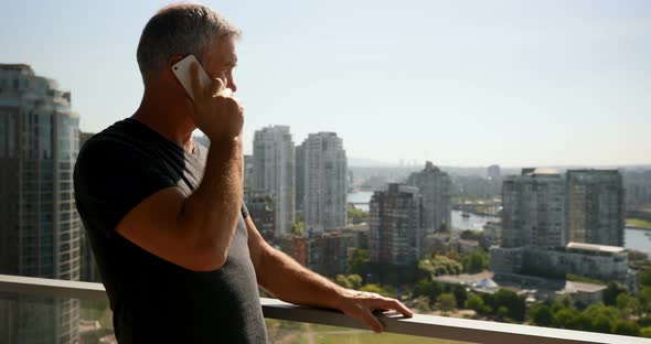 Man talking on mobile phone in balcony 4k