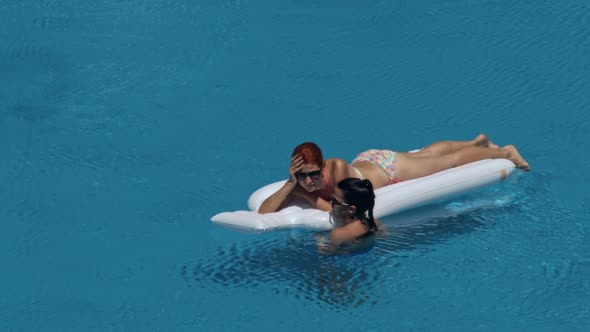 Beautiful Girlfriends Having Fun in Swimming Pool