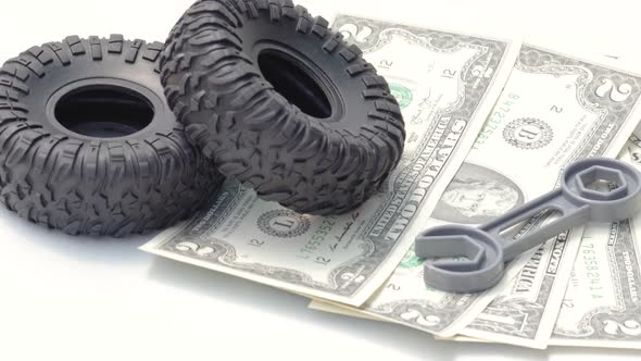 one back tire is rolling on dollars.car repair and maintenance,tires replacement.