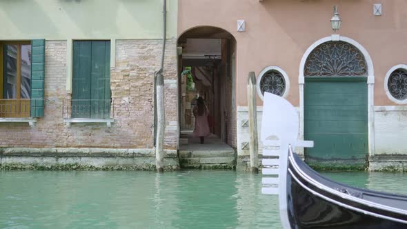 Woman Walks Through Narrow Passage After Sailing on Boat