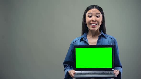 Extremely Happy Woman Holding Laptop With Green Screen, Big Winnings Online