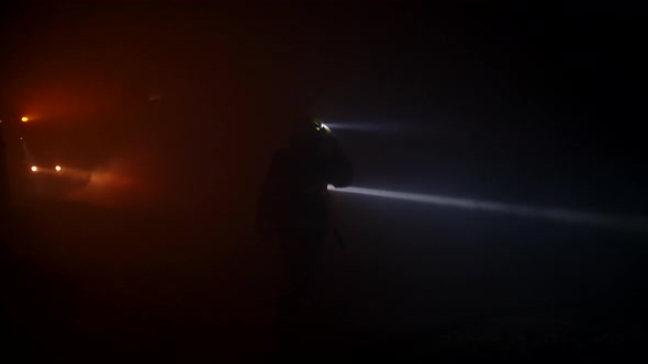 Firefighters during a rescue operation in a dark tunnel filled with smoke