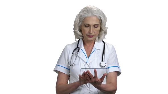 Smiling Senior Doctor Using Transparent Digital Tablet