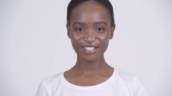 Face of Young Happy African Woman Smiling Against White Background