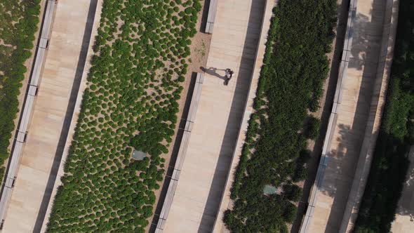 Aerial View - a Woman Rides on Electric Eco-friendly Transport Without Harmful Emissions