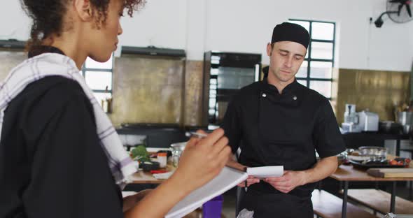 Caucasian female chef teaching diverse group