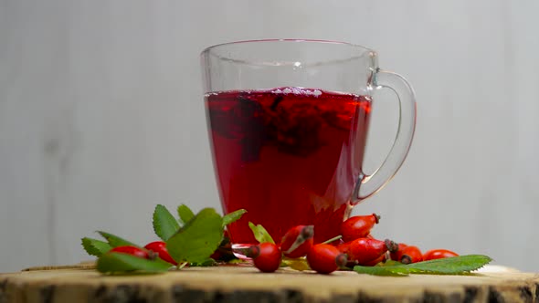 Rosehip Red Tea, Homeopathic Drink For Human Health. Red Berry   Medicinal On A Spinning Table.