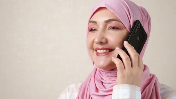 Young Caucasian Muslim Woman Talking on the Phone