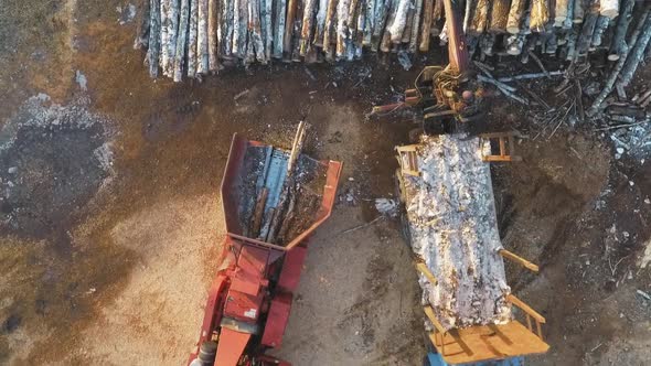 A Truck With Manipulator Loads Firewood Into A Shredder For Firewood