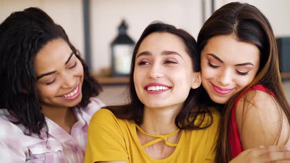 Young woman showing engagement ring to friends