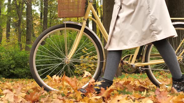 Woman Walks in Park Kicking Fallen Leaves Heap with Boots