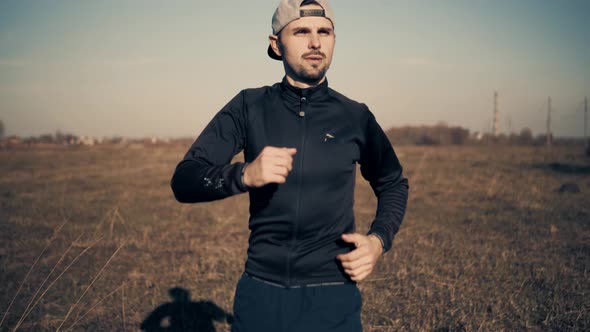 Athlete Relaxing After Run Workout Outdoor.Portrait Jogger Running Exercise Athlete Training.