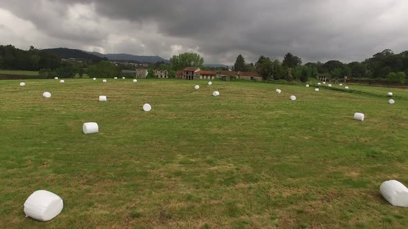 Field with haystacks. Haystacks on sloping field