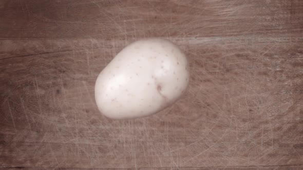 Potato Falling on Black Surface and Slices