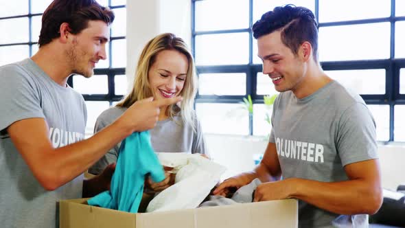 Volunteers going through donation box of clothes