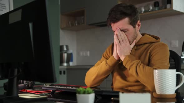 Man Works at Home Office Remotely Using Computer