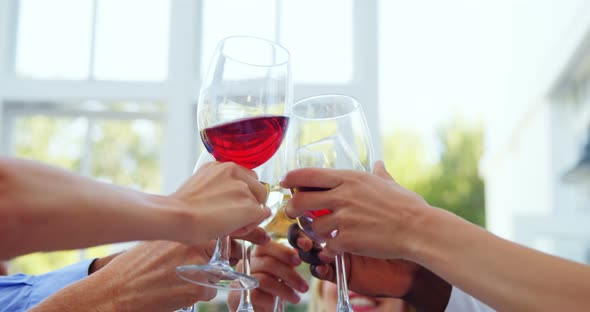 Group of friends toasting glasses of wine