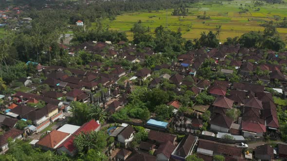 Low Flying Aerial Shot Over the Rooftops of the Houses in a Dense Residential Neighborhood in Bali