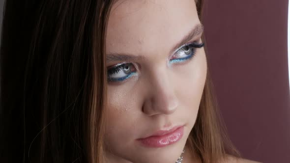 Portrait of a Beautiful Young Girl Model in Stylish Evening Make Up Smoky Eyes Posing