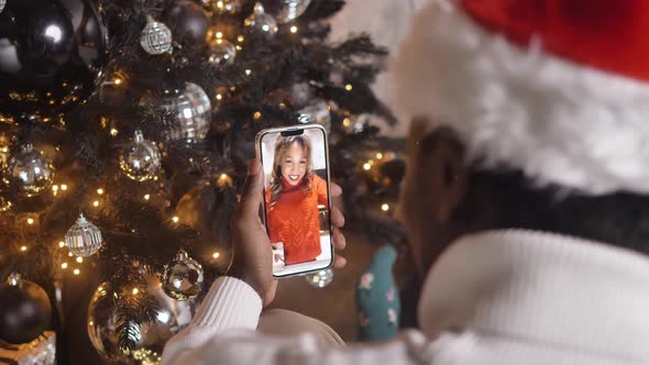 Young Man Talks to Girlfriend Standing Near Christmas Tree