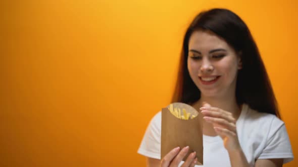 Hand Giving French Fries to Girl, Society Accustoms Generation to Junk Food