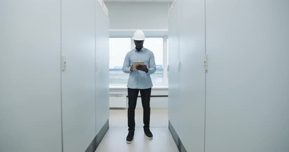 Portrait of an Engineer in a Hard Hat Holding a Tablet