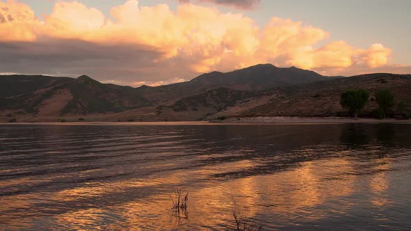 Relaxing view of colorful sunrise reflecting clouds in lake