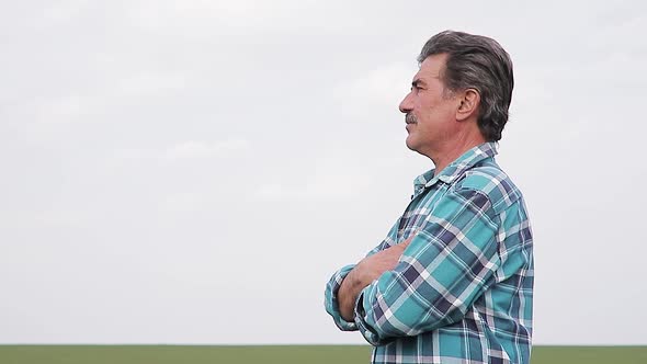 Portrait of Farmer Standing in a Wheat Field