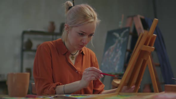 Portrait of Creative Woman Painter Working in Art Studio