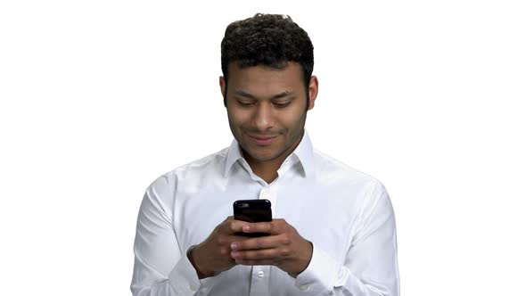 Indian Businessman Typing Message on Mobile Phone