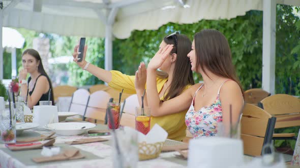 Online Communication, Attractive Young Girls in Restaurant and Talking with Friend Via Video Call on