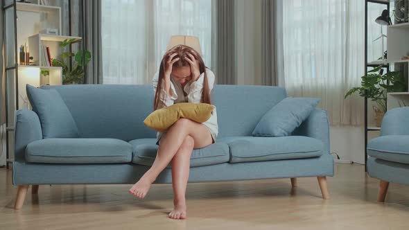 Unhappy Lonely Depressed Young Asian Woman At Home, She Is Sitting On The Couch, Depression Concept