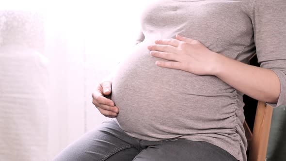 Pregnant Woman with Big Belly Relax at Home