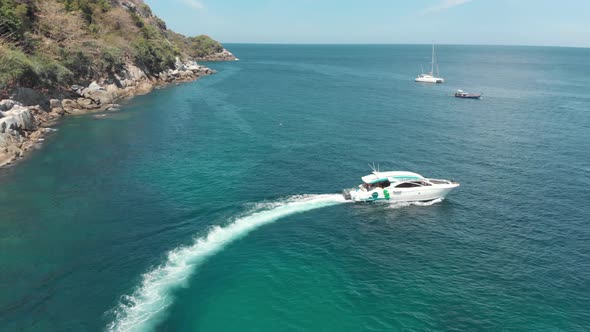 Recreational motorboat makes a turn at sea. Tropical waters. Tracking shot