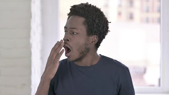 Portrait of African Man Yawning in Office