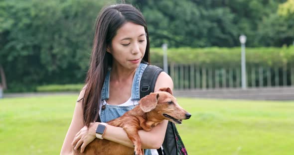 Woman hugging with her dog at outdoor park