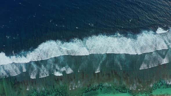 Aerial Top View Powerful Waves on Blue Turquoise Ocean Crashing and Foaming