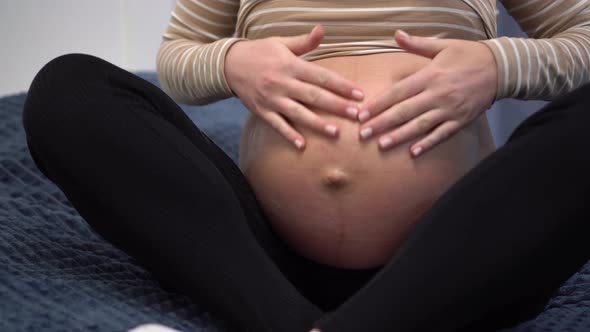 Young Pregnant Woman with Smears Cream on Her Belly