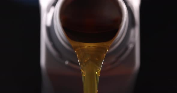 Yellow Transparent Machine Oil is Pouring From Bottle  Movie