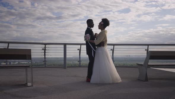 Slow Dance of Happy Confident African American Couple of Newlyweds on Romantic Summer Bridge