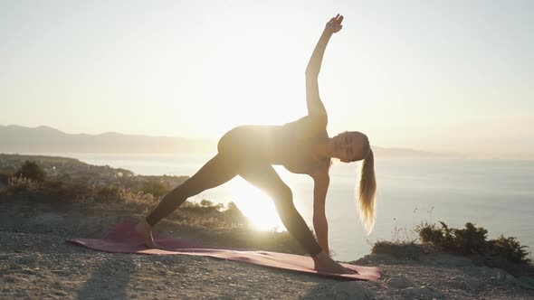 Silhouette of Woman Doing Yoga Exercise, Stretching in Ray of Sun, Slow Motion