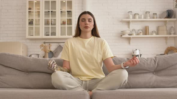 Calm Woman with Metal Bionic Arm Does Breathing Exercises