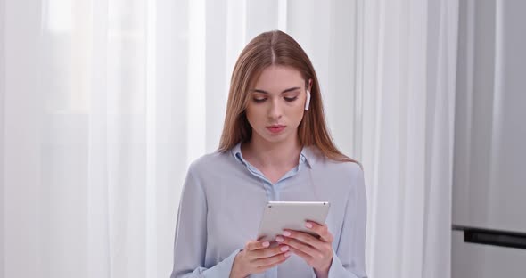 Young Woman Freelancer at Shirt, Working Using a Screen Tablet, Remote Work From Home, Female in