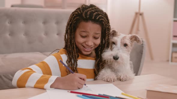 African Girl Drawing and Kissing Dog