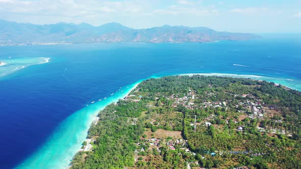 Tropical overhead island view of a white sandy paradise beach and blue water background in 4K