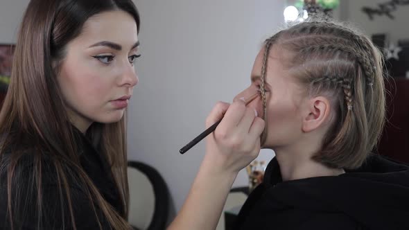 Side View of Make Up Artist Work with Beautiful Blond Hair Model