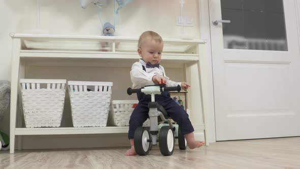 Kid on Baby Bicycle Balance Bike for Toddlers with Colorful Balloons 1 Year Old Baby Boy Celebrating